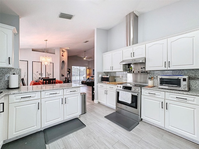 kitchen featuring stainless steel appliances, tasteful backsplash, and white cabinets