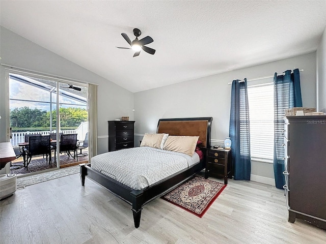 bedroom featuring ceiling fan, lofted ceiling, light wood-style floors, a textured ceiling, and access to outside