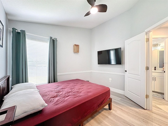 bedroom with baseboards, a textured ceiling, a ceiling fan, and light wood-style floors