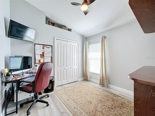 office area with lofted ceiling, wood finished floors, baseboards, and a textured ceiling