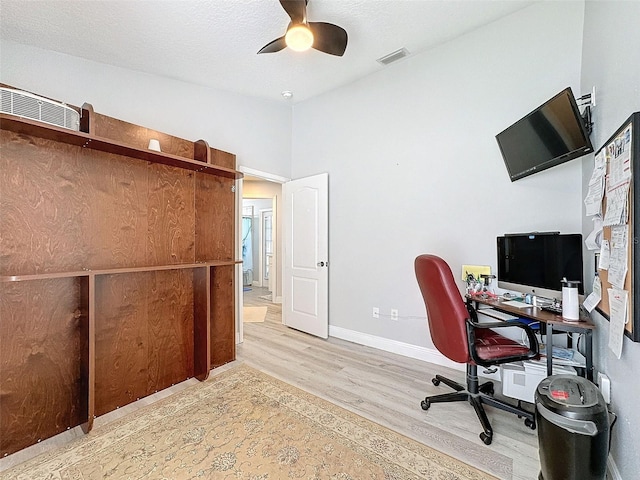 office area with visible vents, a ceiling fan, a textured ceiling, wood finished floors, and baseboards