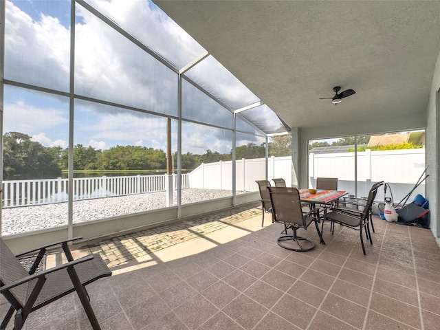 sunroom featuring a ceiling fan