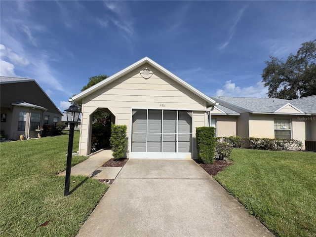 single story home with a garage and a front lawn