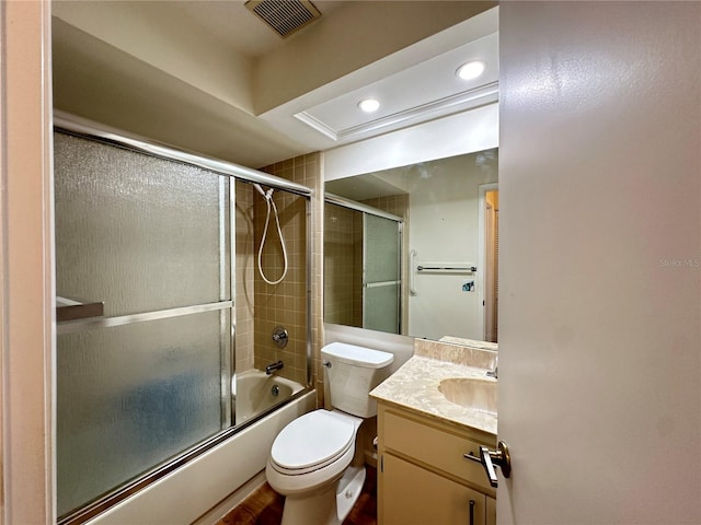 full bathroom with shower / bath combination with glass door, toilet, and vanity