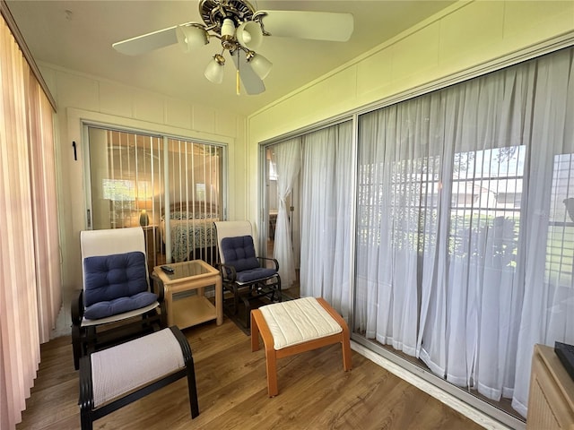 sunroom / solarium featuring ceiling fan