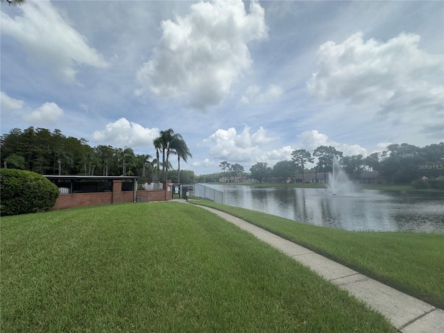 view of home's community with a yard and a water view