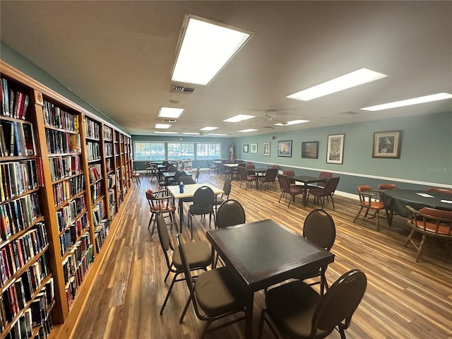 dining space with hardwood / wood-style floors