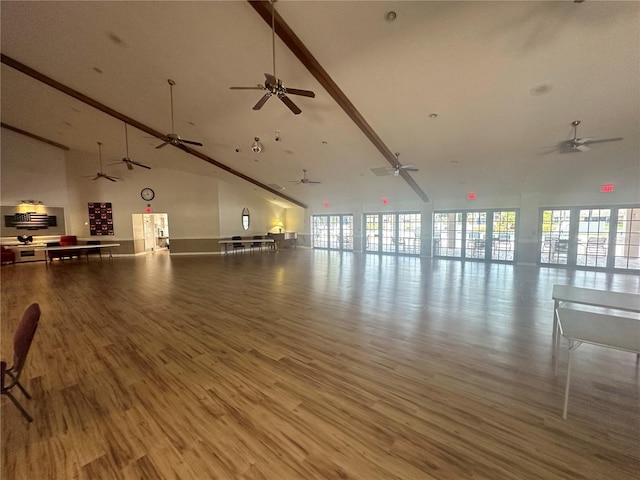 interior space featuring hardwood / wood-style flooring, high vaulted ceiling, and ceiling fan