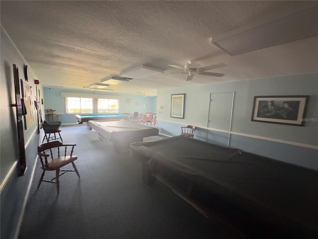 recreation room with a textured ceiling, carpet floors, ceiling fan, and pool table