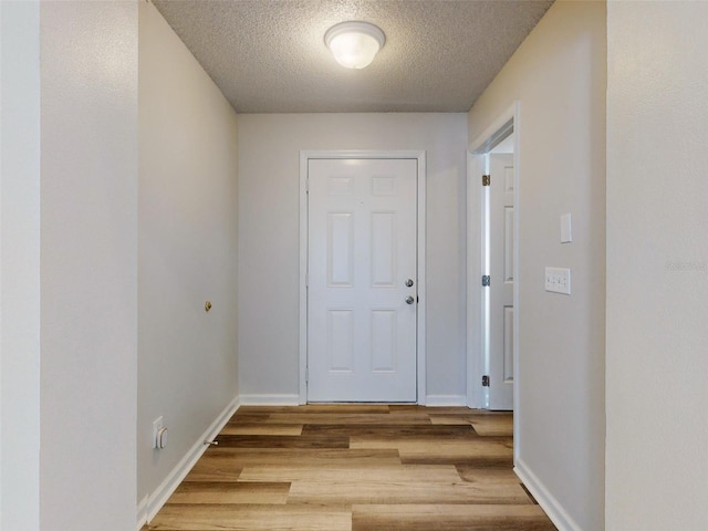 foyer featuring light hardwood / wood-style floors and a textured ceiling