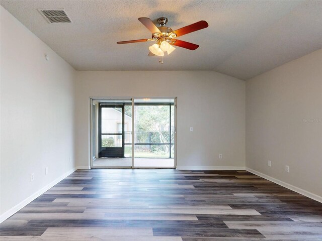 spare room with a textured ceiling, dark hardwood / wood-style flooring, ceiling fan, and lofted ceiling