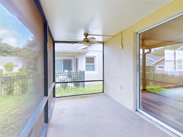 unfurnished sunroom featuring ceiling fan