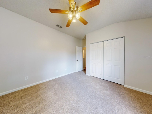 unfurnished bedroom featuring a closet, carpet flooring, and ceiling fan