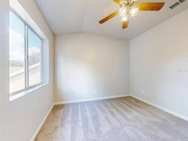 carpeted empty room with lofted ceiling and ceiling fan