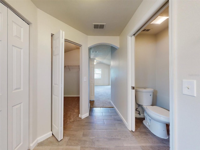 bathroom featuring wood-type flooring and toilet