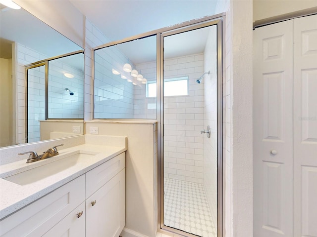 bathroom featuring vanity and an enclosed shower