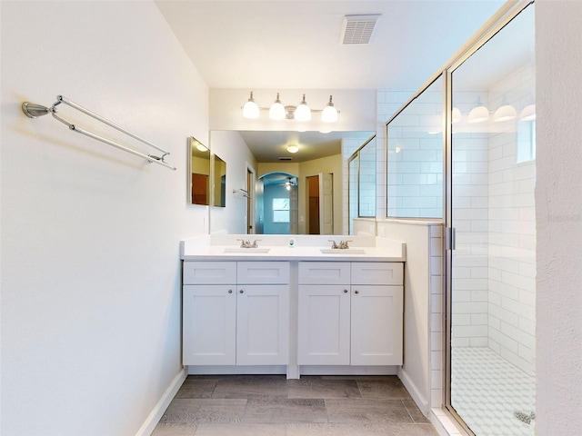 bathroom with vanity, wood-type flooring, and an enclosed shower