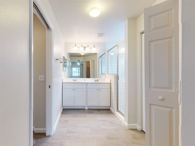 bathroom featuring an enclosed shower and vanity