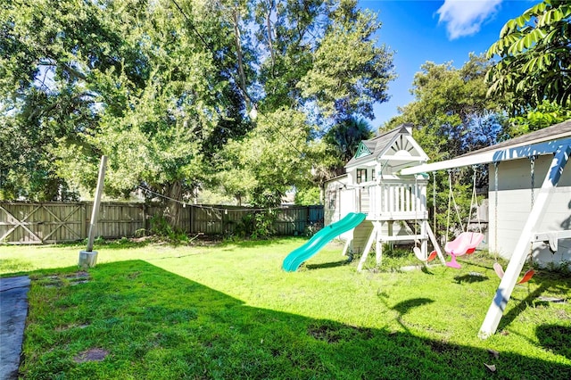 view of playground with a lawn