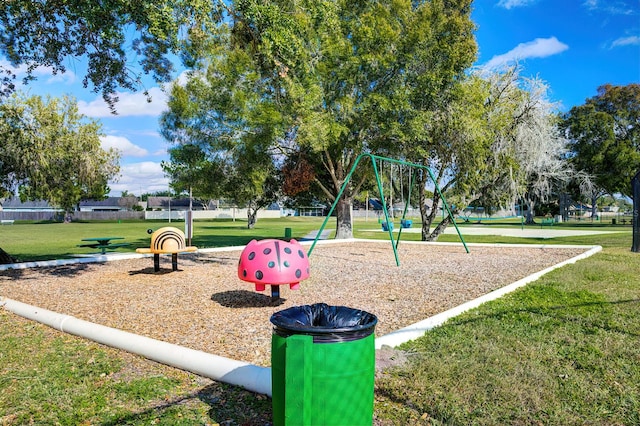 view of playground with a lawn