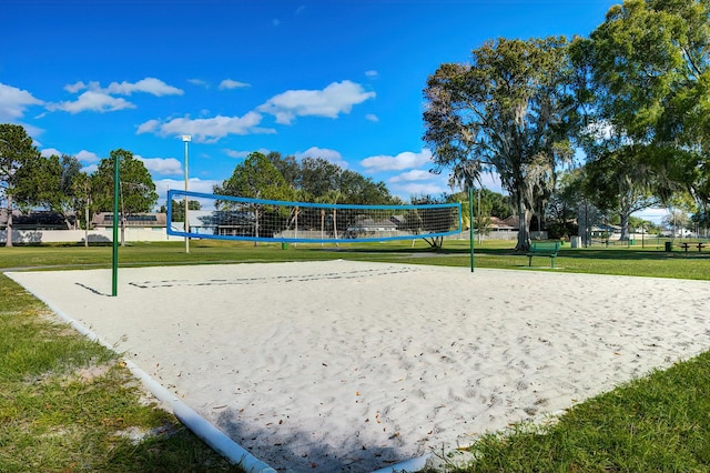 view of home's community featuring volleyball court and a yard