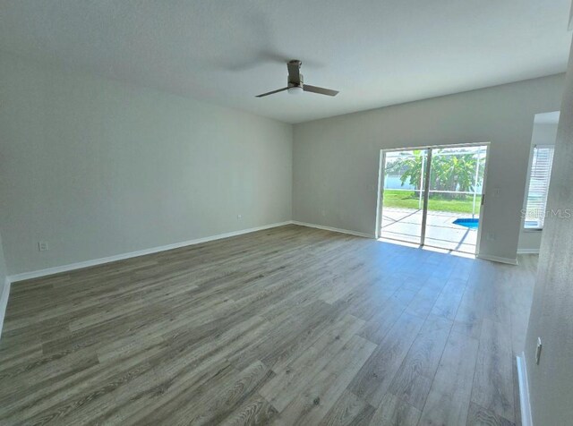 empty room featuring ceiling fan and wood-type flooring