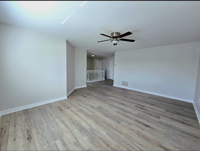 unfurnished living room with ceiling fan and light hardwood / wood-style flooring