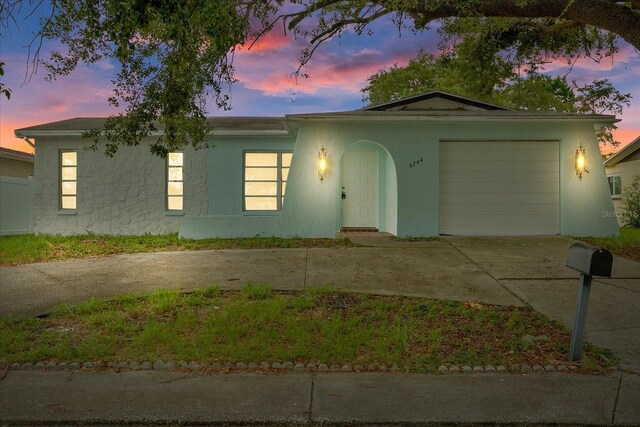 ranch-style home featuring a garage