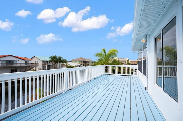 wooden deck featuring a water view and a residential view