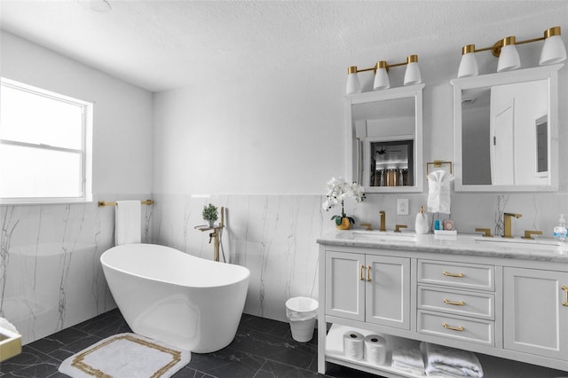 bathroom featuring tile walls, double vanity, a bathtub, and tile patterned floors