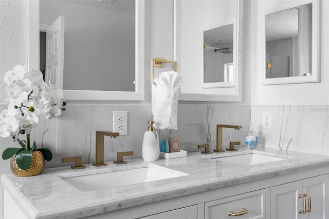 bathroom featuring double vanity, tasteful backsplash, and a sink