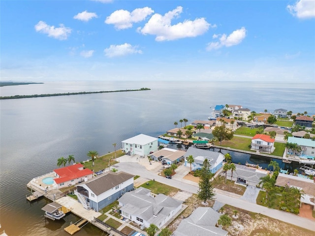 birds eye view of property with a water view and a residential view