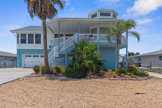 coastal inspired home with a garage and a porch