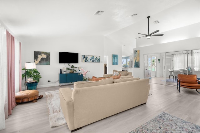 living room with light wood-type flooring, high vaulted ceiling, and ceiling fan