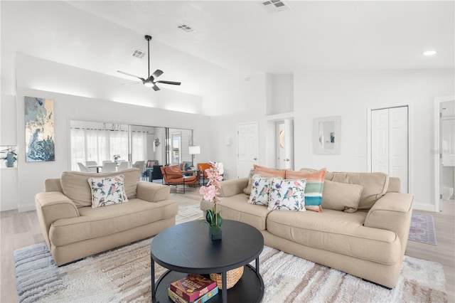 living area with light wood finished floors, ceiling fan, and visible vents