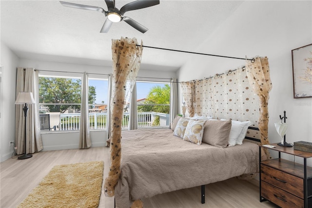 bedroom featuring a textured ceiling, access to outside, and light wood-type flooring