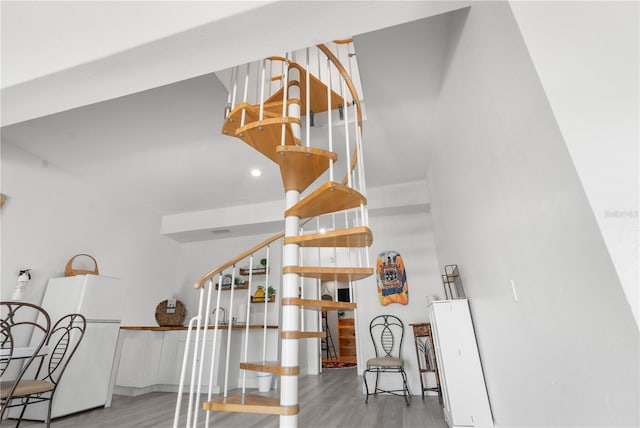 stairs featuring hardwood / wood-style flooring