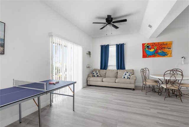 living room featuring a wealth of natural light, light hardwood / wood-style floors, and ceiling fan