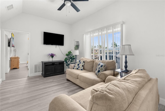 living area featuring light wood-style floors, visible vents, vaulted ceiling, and ceiling fan