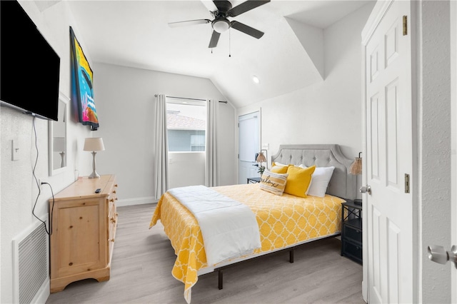 bedroom featuring ceiling fan, vaulted ceiling, and light hardwood / wood-style floors