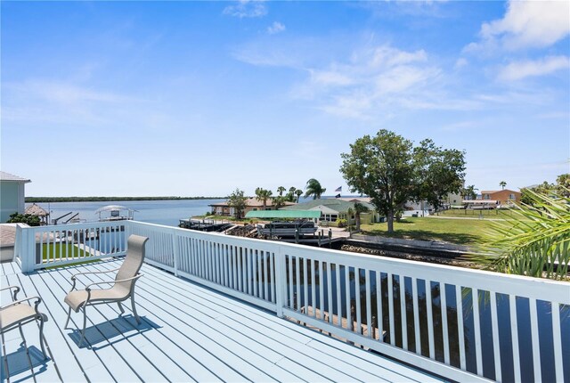 wooden terrace featuring a water view