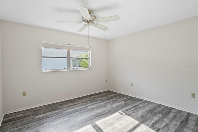 empty room featuring ceiling fan and dark hardwood / wood-style flooring