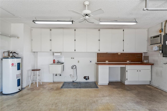 interior space featuring ceiling fan, sink, a wall mounted air conditioner, a workshop area, and water heater