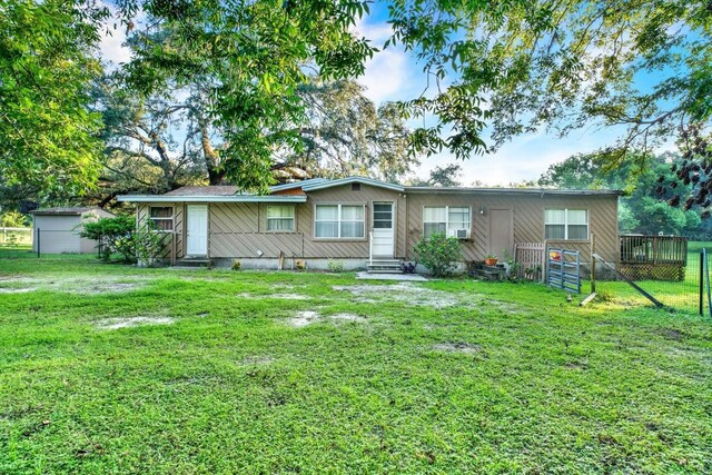 rear view of house featuring a lawn