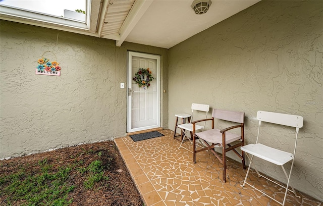 view of exterior entry featuring a patio