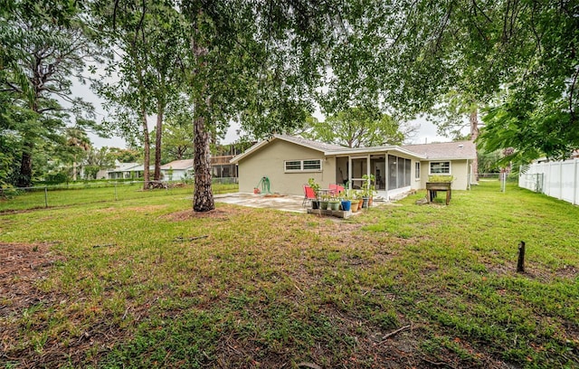 view of yard featuring a patio and a sunroom