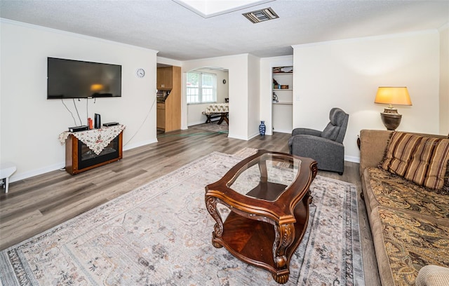 living room with a textured ceiling and hardwood / wood-style floors