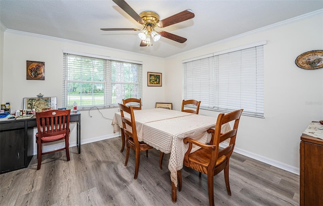 dining room featuring ceiling fan, hardwood / wood-style flooring, and ornamental molding