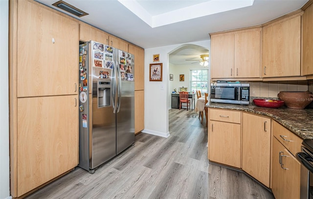 kitchen with stainless steel appliances, light brown cabinets, light wood-type flooring, and ceiling fan