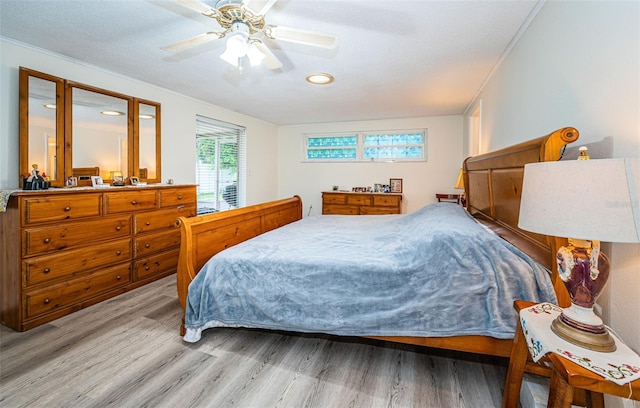 bedroom featuring a textured ceiling, wood-type flooring, and ceiling fan